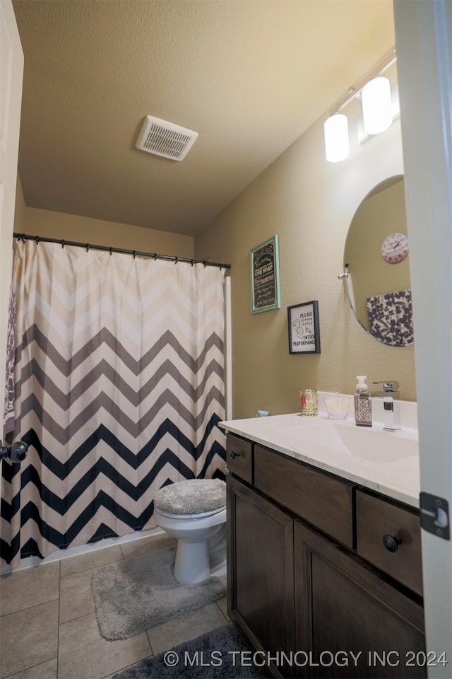 bathroom featuring tile patterned floors, vanity, and toilet