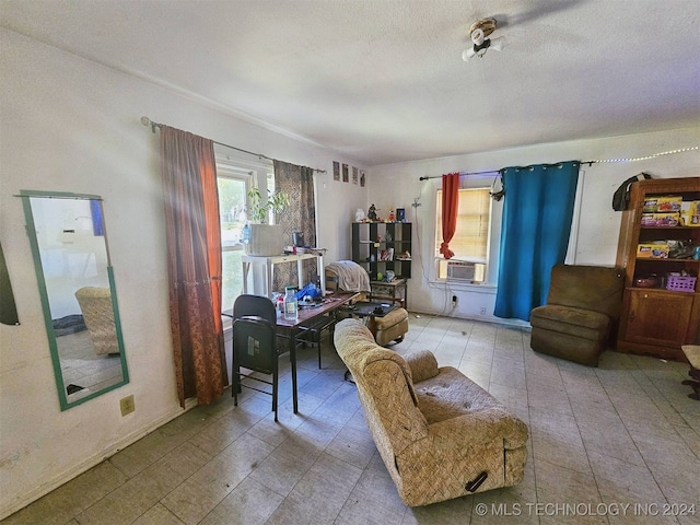 living room with cooling unit and a textured ceiling