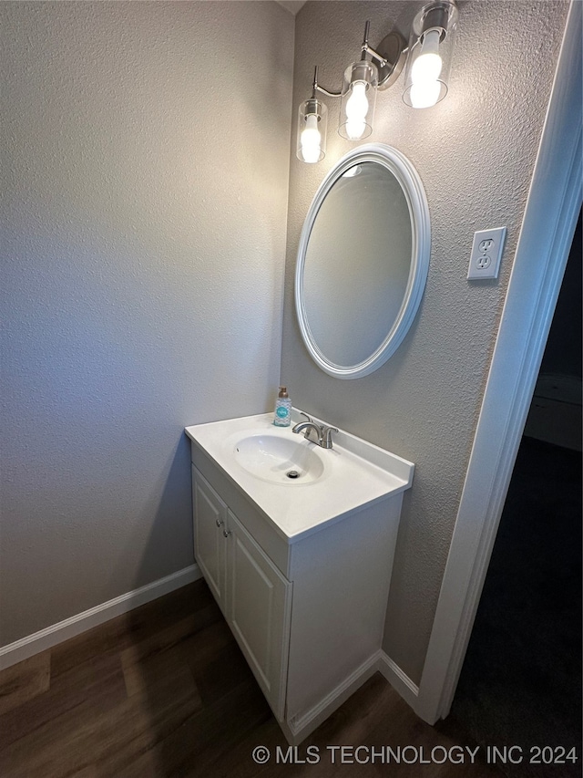 bathroom with vanity and hardwood / wood-style floors