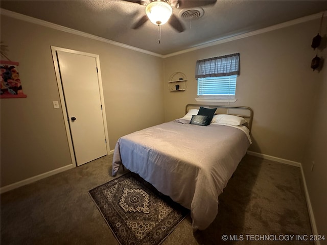 bedroom featuring ceiling fan, dark colored carpet, and ornamental molding