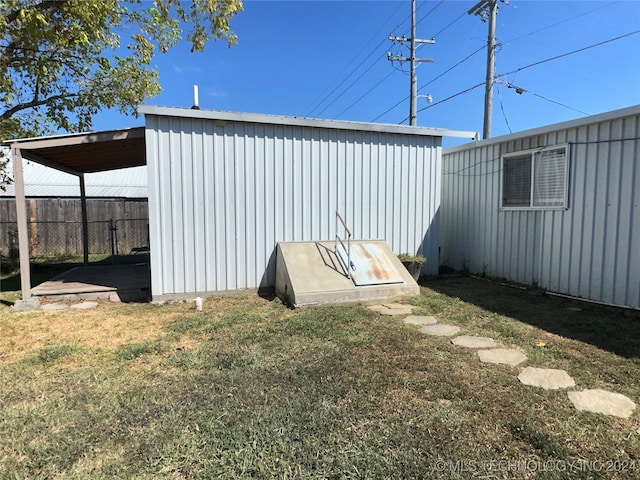 view of outbuilding with a lawn