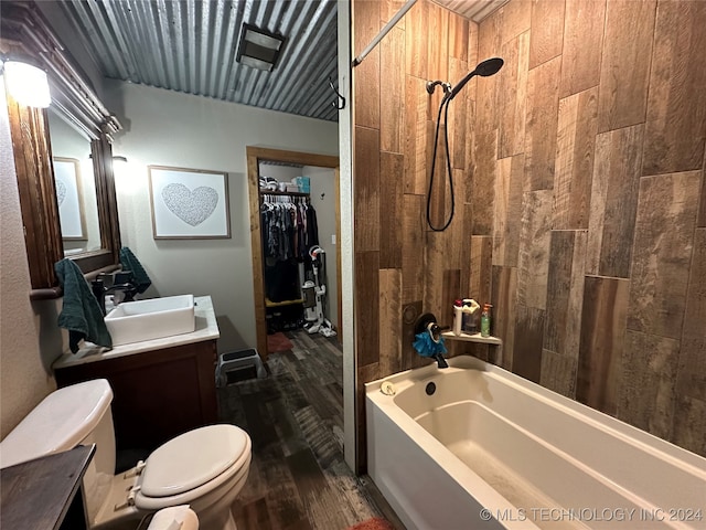 full bathroom with vanity, tiled shower / bath combo, toilet, and hardwood / wood-style flooring