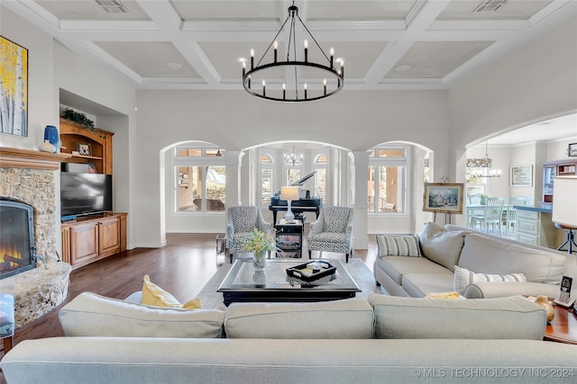 living room with a chandelier, coffered ceiling, dark hardwood / wood-style floors, and a fireplace