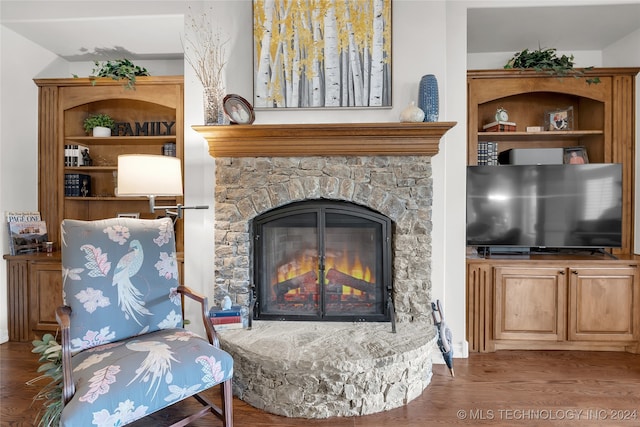 sitting room featuring wood-type flooring and a fireplace