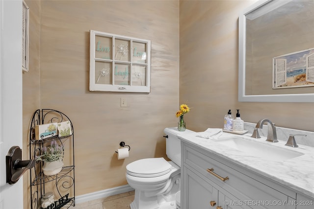 bathroom with vanity, tile patterned flooring, and toilet