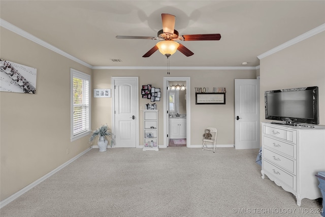 interior space featuring crown molding, connected bathroom, ceiling fan, and light colored carpet