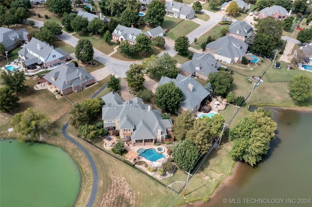 birds eye view of property with a water view