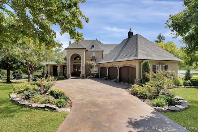 french provincial home featuring a front yard