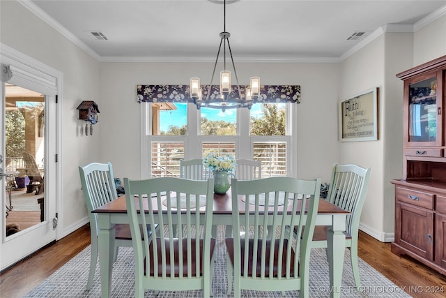 dining room with a chandelier, crown molding, and dark hardwood / wood-style flooring