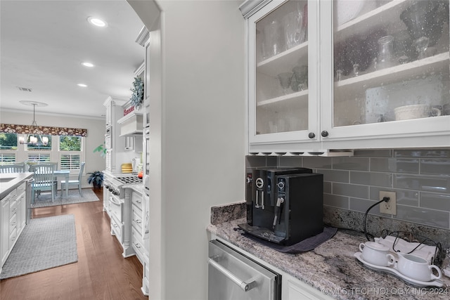 kitchen featuring light stone countertops, decorative light fixtures, decorative backsplash, and white cabinetry