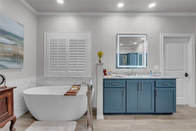 bathroom with vanity, a tub, hardwood / wood-style flooring, tile walls, and crown molding