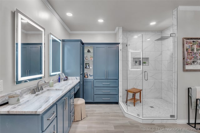 bathroom featuring ornamental molding, vanity, hardwood / wood-style floors, and a shower with shower door