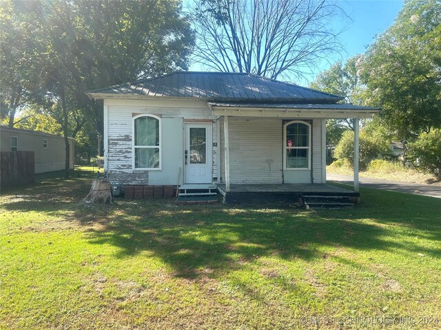 rear view of property with a lawn