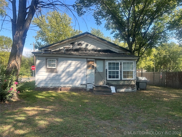 back of house with a yard