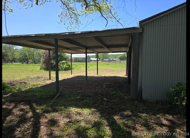 view of car parking featuring a carport and a yard