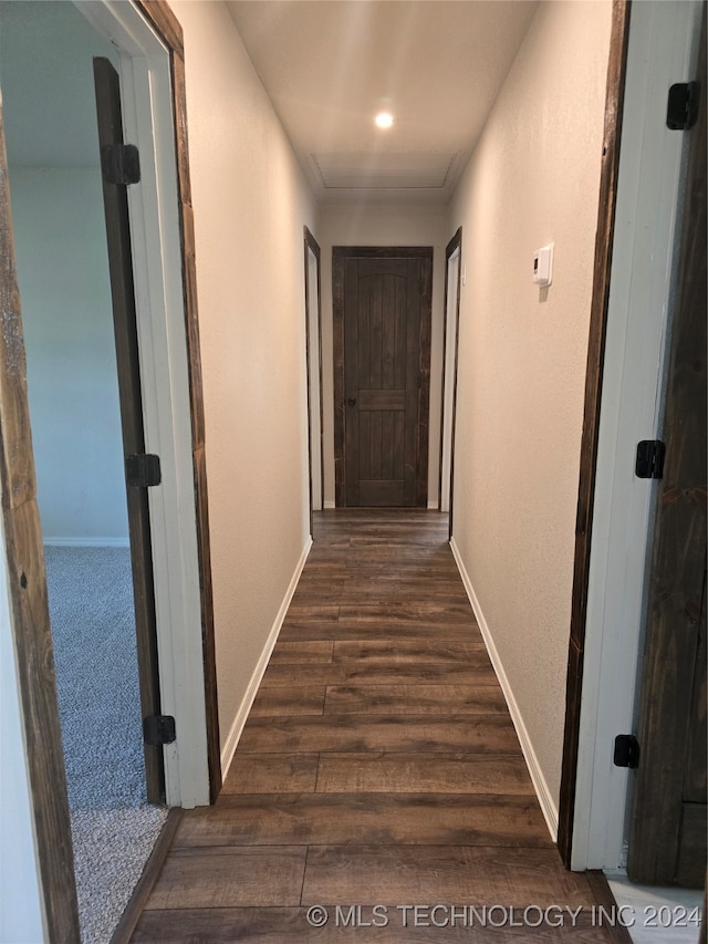 corridor with dark hardwood / wood-style floors