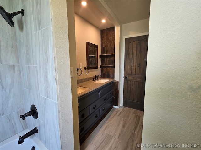 bathroom with vanity and  shower combination