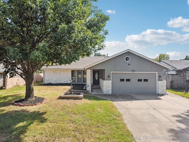 view of front of home with a front lawn and a garage