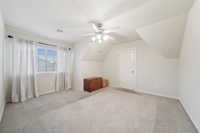 bonus room featuring lofted ceiling, light carpet, and ceiling fan