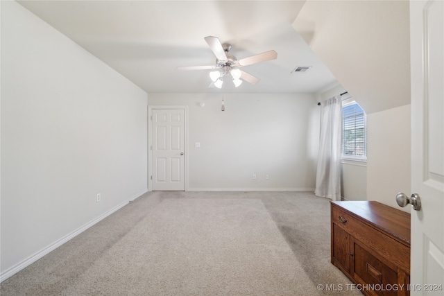 interior space with ceiling fan and light colored carpet