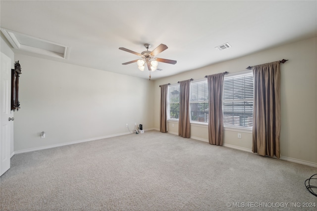 carpeted empty room featuring ceiling fan