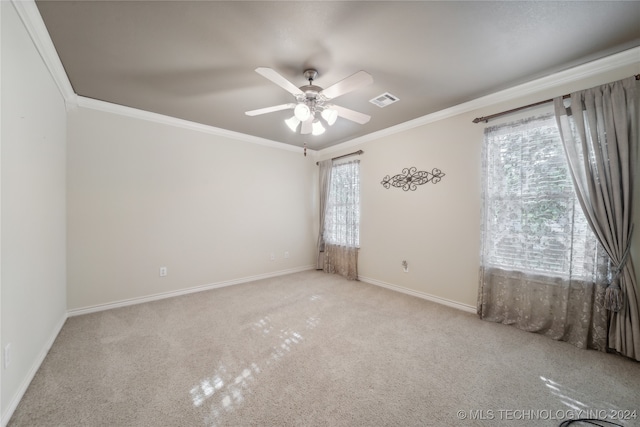 empty room with ornamental molding, light carpet, and ceiling fan