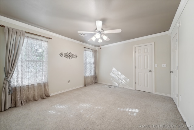 unfurnished bedroom with multiple windows, crown molding, ceiling fan, and light colored carpet