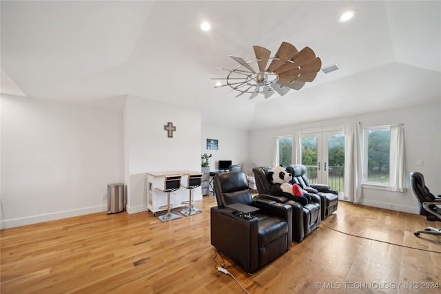 living room with french doors, lofted ceiling, visible vents, light wood-style floors, and baseboards