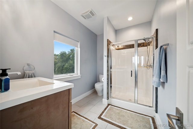 full bathroom featuring visible vents, toilet, a shower stall, vanity, and tile patterned flooring