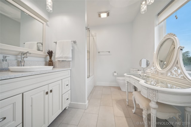 full bath with tile patterned flooring, toilet, bath / shower combo with glass door, a sink, and visible vents