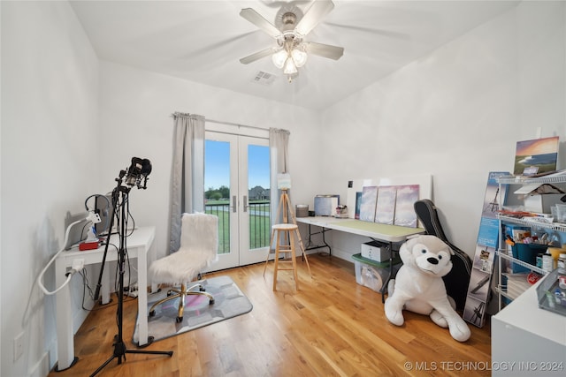 home office with french doors, wood finished floors, visible vents, and a ceiling fan