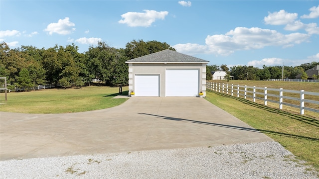 detached garage featuring fence