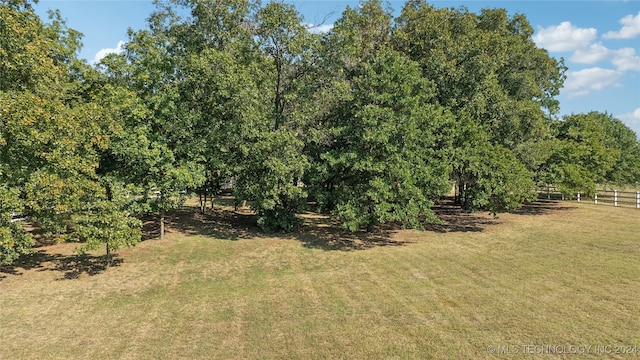 view of yard featuring a rural view and fence