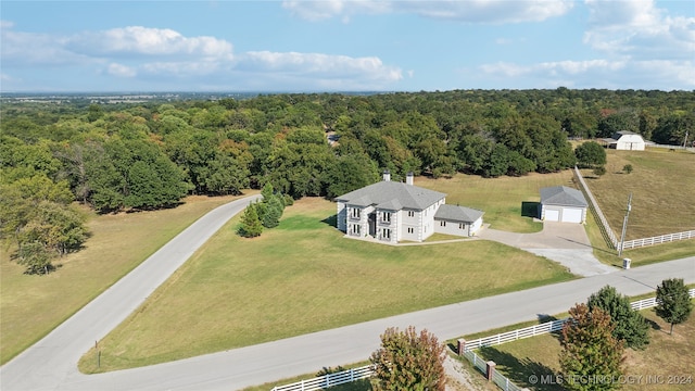 birds eye view of property with a rural view and a wooded view