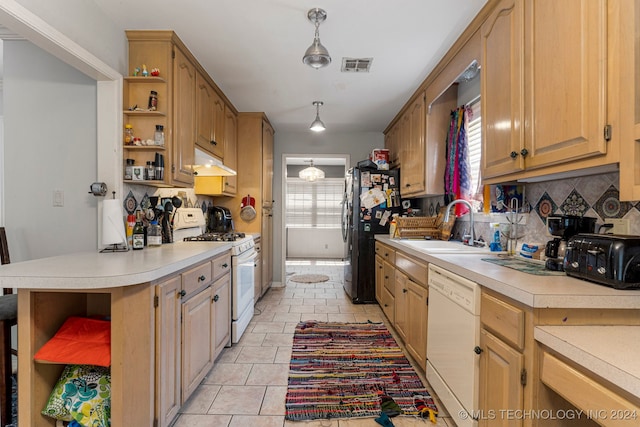 kitchen with tasteful backsplash, light tile patterned floors, pendant lighting, sink, and white appliances