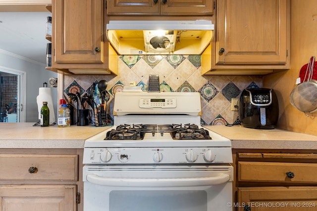 kitchen featuring extractor fan, ornamental molding, decorative backsplash, and gas range gas stove