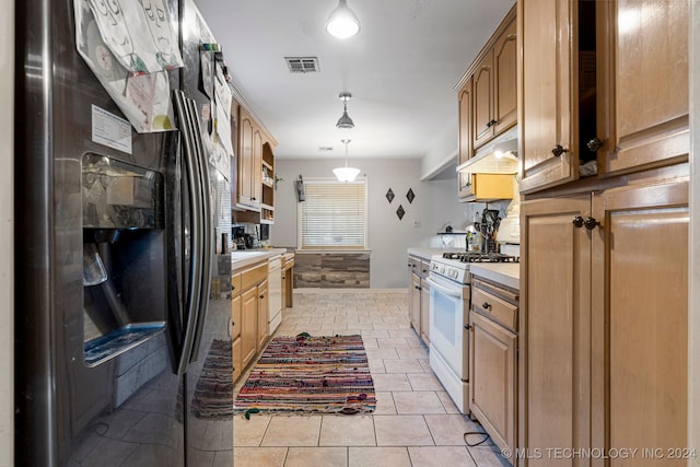 kitchen featuring light tile patterned floors, pendant lighting, and white appliances