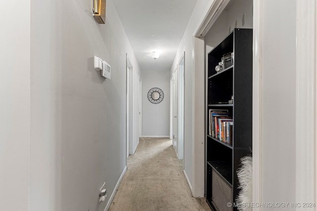 hall with light colored carpet