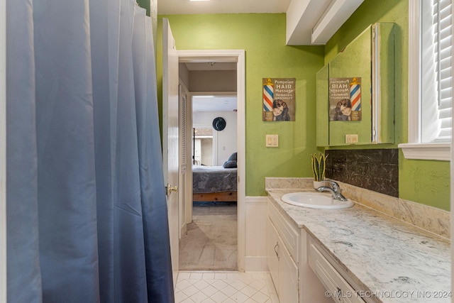 bathroom featuring vanity, decorative backsplash, and tile patterned flooring