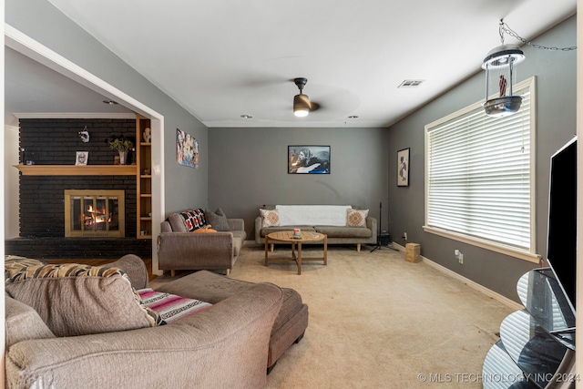 carpeted living room featuring a fireplace and ceiling fan