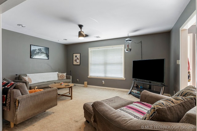 carpeted living room with ceiling fan