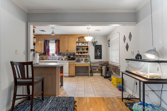 kitchen with white dishwasher, light hardwood / wood-style flooring, plenty of natural light, and hanging light fixtures