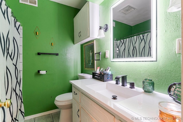 bathroom featuring vanity, toilet, and tile patterned flooring