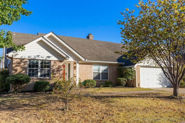 view of front facade featuring a front yard and a garage