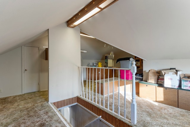 additional living space featuring carpet flooring and vaulted ceiling with beams