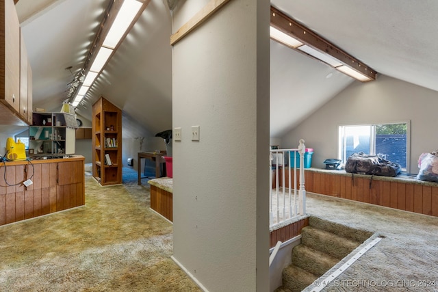 bonus room with light carpet and lofted ceiling with beams