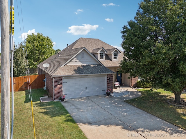 view of front of home featuring a garage and a front lawn