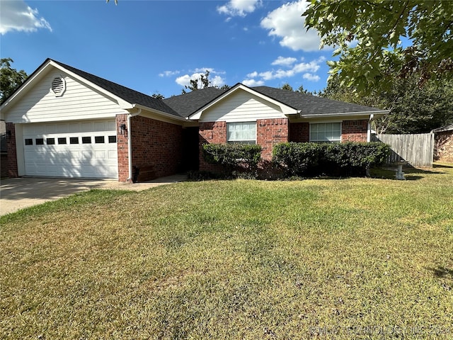 ranch-style house featuring a front lawn and a garage