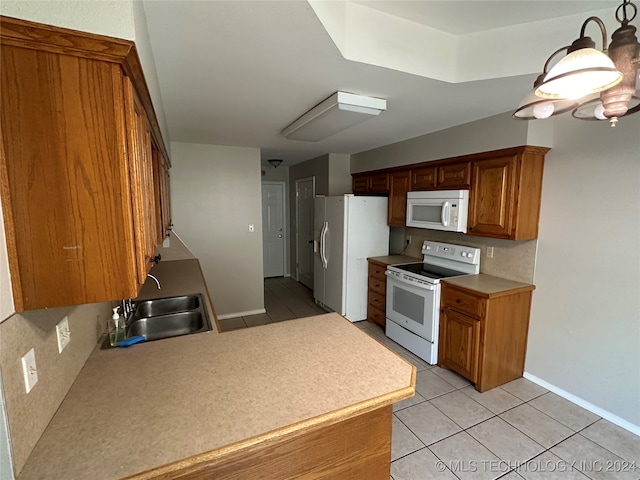 kitchen featuring white appliances, light tile patterned floors, and sink