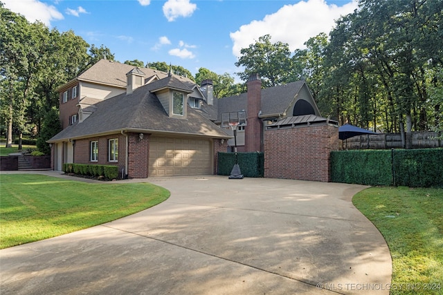 view of front of home with a front yard and a garage